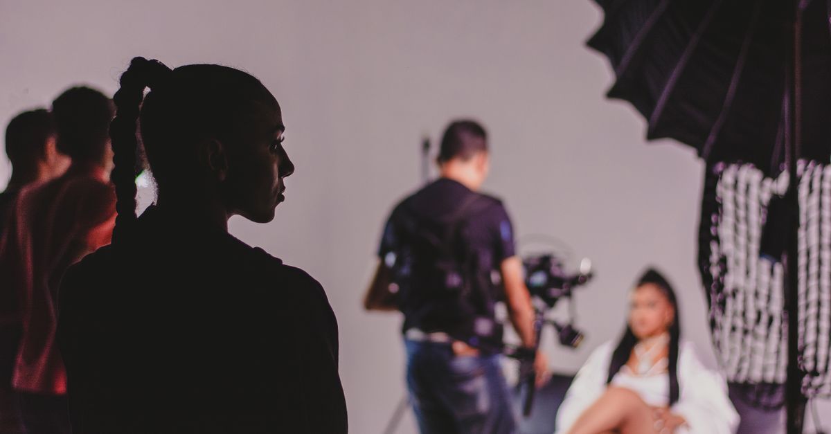 Capturing the essence of a fashion photo shoot with models and photographers in a studio.